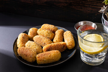 Typical croquettes of Spanish cuisine. Traditional tapas of Spanish cuisine. Tapas plate with croquettes with dark background