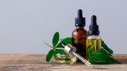Cannabis oil in bottles on gray background with copy space, banner
