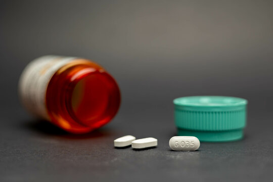 Fort Myers, Florida/ USA -7-31-21: Hydrocodone Pills and Prescription Bottle isolated on black background 