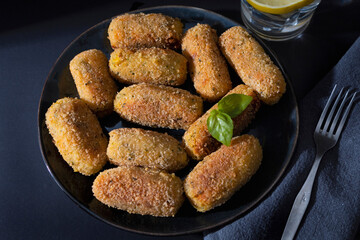 Typical croquettes of Spanish cuisine. Traditional tapas of Spanish cuisine. Tapas plate with croquettes with dark background