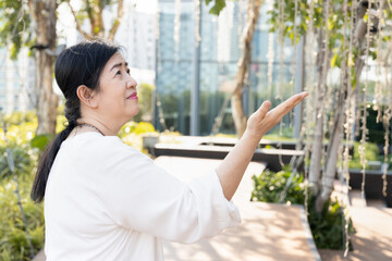 Senior woman pointing hand up