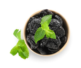 Bowl with tasty prunes on white background
