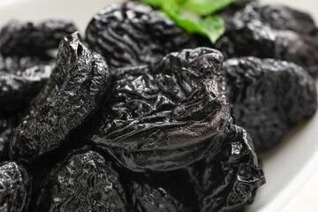 Tasty prunes on table, closeup