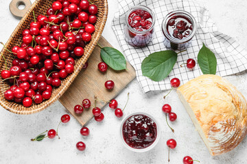 Composition with ripe cherry, jam and bread on light background