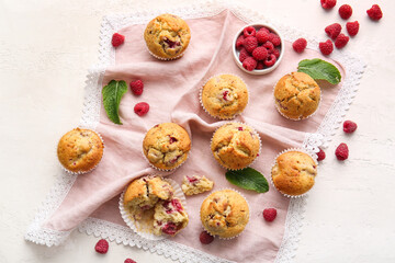 Tasty raspberry muffins on light background