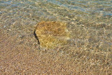 Surface of clear water on tropical sandy beach in Crete Greece.