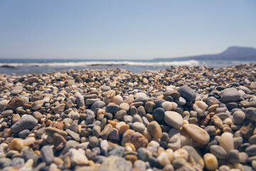 Pebble beach on the coast of Crete on the Aegean Sea.