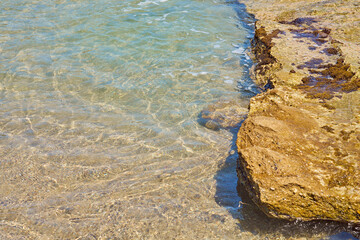 Surface of clear water on tropical sandy beach in Crete Greece.