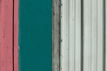 Fototapeta na wymiar wooden wall with some corrugated metal siding