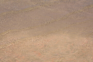 Surface of clear water on tropical sandy beach in Crete Greece.