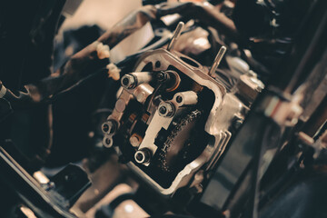 Set the valve on the cylinder head of the motorcycle engine by a technician.