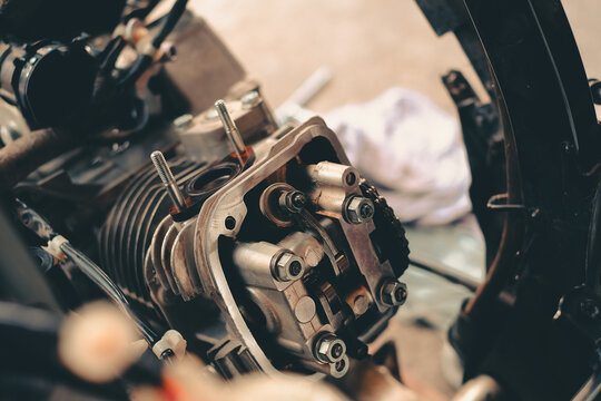 Set the valve on the cylinder head of the motorcycle engine by a technician.