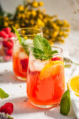 Cold drink. Orange drink with mint and fruits. Fresh drink in glass. Summer drink. Drink from beach...