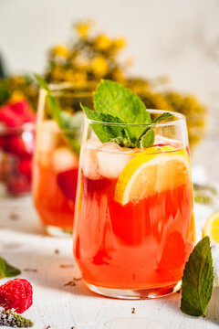 Cold drink. Orange drink with mint and fruits. Fresh drink in glass. Summer drink. Drink from beach bar.