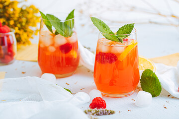 Cold drink. Orange drink with mint and fruits. Fresh drink in glass. Summer drink. Drink from beach bar.