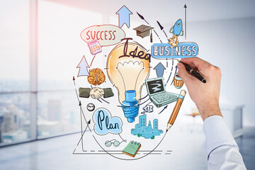 Businessman hand drawing colorful light bulb as a concept of new idea for start up. Concept of...