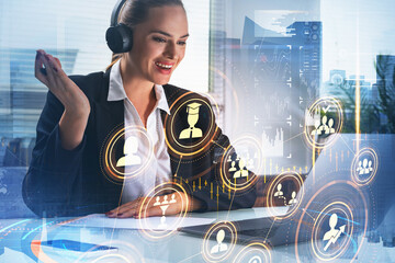 Businesswoman working on laptop in headphones and taking participation at video conference call. Social media icons hologram, Singapore city view, double exposure