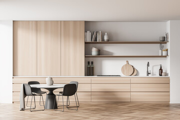 Light white kitchen with opened shelves and round dining table