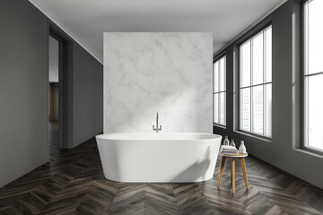 Fototapeta na wymiar Grey walkways and white partition with bathtub in the bathroom space