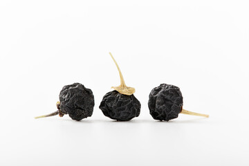 Black goji berry or black wolfberry with isolated white background.