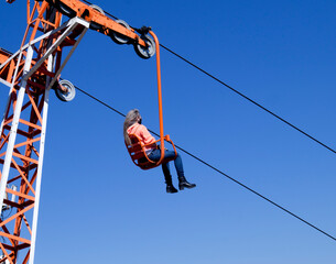 Woman in chair lift going down the mountain, in Serra Negra, São Paulo, Brazil - July 26, 2021
