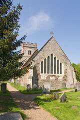 Fototapeta na wymiar All Saints church at Ockham, Surrey, with a rare seven lancet window in the east end of the chancel
