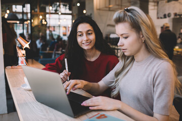 Content female coworkers doing remote work