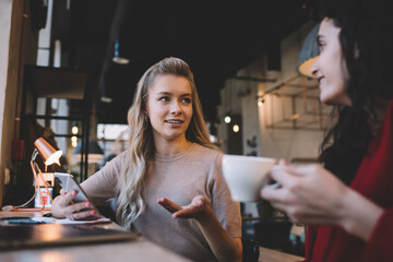 Young women discussing about exam in cafe