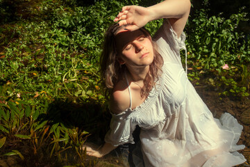 woman with white dress near stream of water