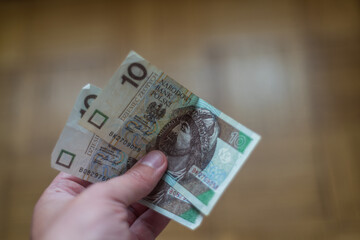 hand holds two Polish banknotes