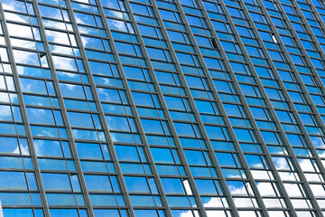 Blue office windows. Windows with a reflection of the sky in a large building