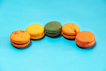 Macaroons on an orange background on an blue cyan background