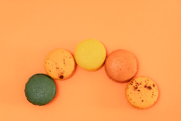 Macaroons on an orange background on an orange background