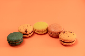 Macaroons on an orange background on an orange background