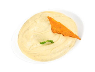 Delicious hummus with nacho chip and parsley in bowl isolated on white, top view