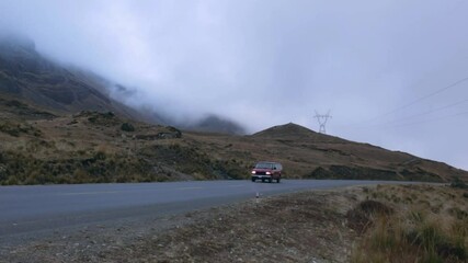 LA PAZ, BOLIVIA - Jul 26, 2021: A red Ford Van driving on a bumpy mountain road in La Cumbre, Bolivia