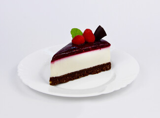 Slice of delicious creamy raspberry cake with jelly topping, raspberries and mint leaf stock images. Slice of cheesecake with raspberries isolated on a white background stock photo