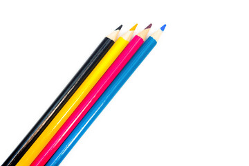 Four colored pencils. The colors cyan, magenta, yellow and black. The concept of polygraphy.