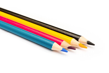 Four colored pencils. The colors cyan, magenta, yellow and black. The concept of polygraphy.