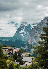 Fototapeta na wymiar Roofs of traditional chalet in Swiss Alps. Switzerland, Jungfrau. Cozy small village in mountains. Scenery landscape, Europe.