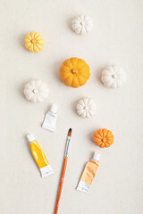 Fototapeta na wymiar Hobby background with handmade gypsum pumpkins, paint brushes and art accessories