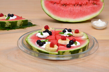 summer fruit dessert with watermelon, berries and cream