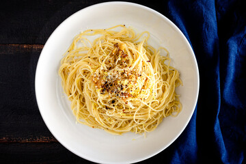 Bowl of Angel Hair Pasta with Roasted Garlic and Parmesan: Angel hair pasta noodles with roasted garlic, parmesan cheese, lemon zest, and red pepper flakes