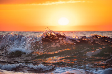 Sea wave close up, low angle view, sunrise shot