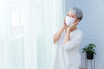 Asian senior woman suffer from cough with face mask protection