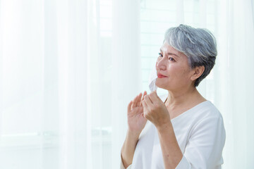 Asian senior woman suffer from cough with face mask protection