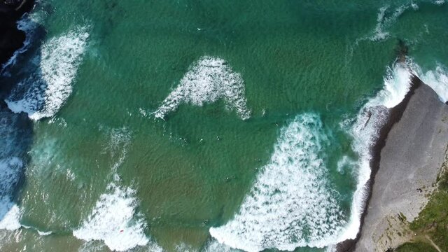 Top down drone shot of a surfen surfing on a wave 4k