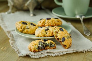 Fresh baked homemade oatmeal cookies with raisins and sunflower seeds on wooden background