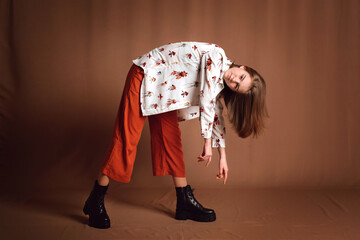 Young pretty woman in stylish clothes. Portrait of a model in fashionable clothes posing in the studio. Modern fashion concept.