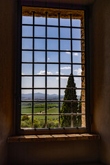 Tuscany landscape through a medieval castle window 